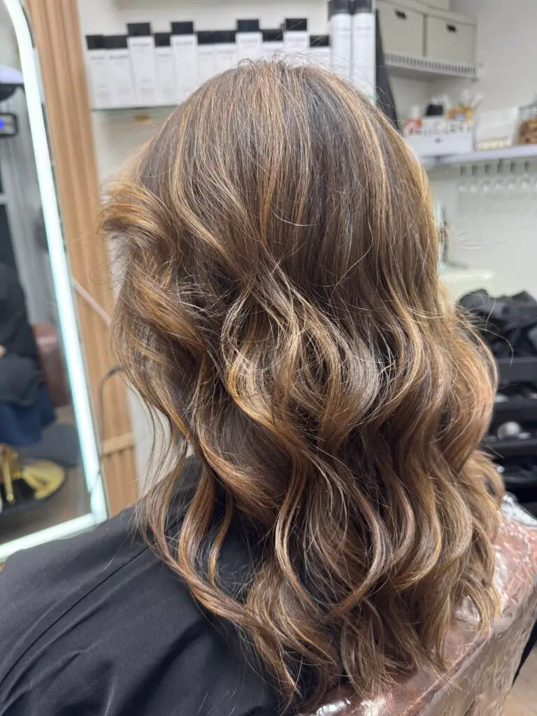 Warm-toned brunette balayage by Fabiana Cohen, at Fabi Pro Beauty, Midtown East Manhattan - soft dimensional and glossy finish.